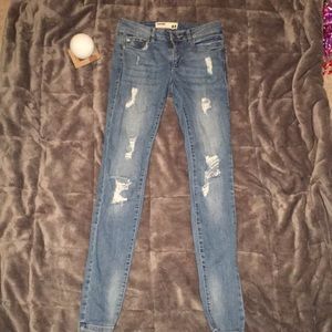 Ripped high waist blue jeans.